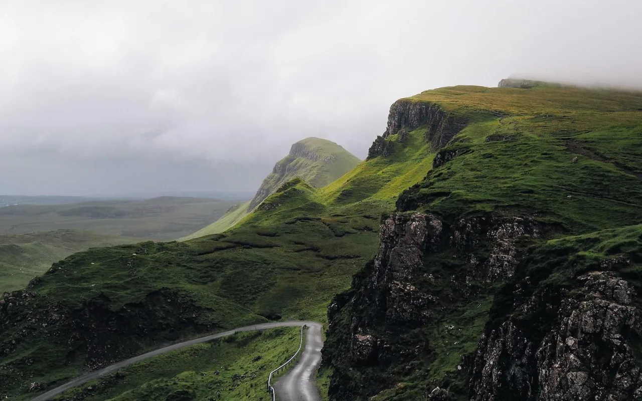 Grassy mountain ridges disappearing into low clouds